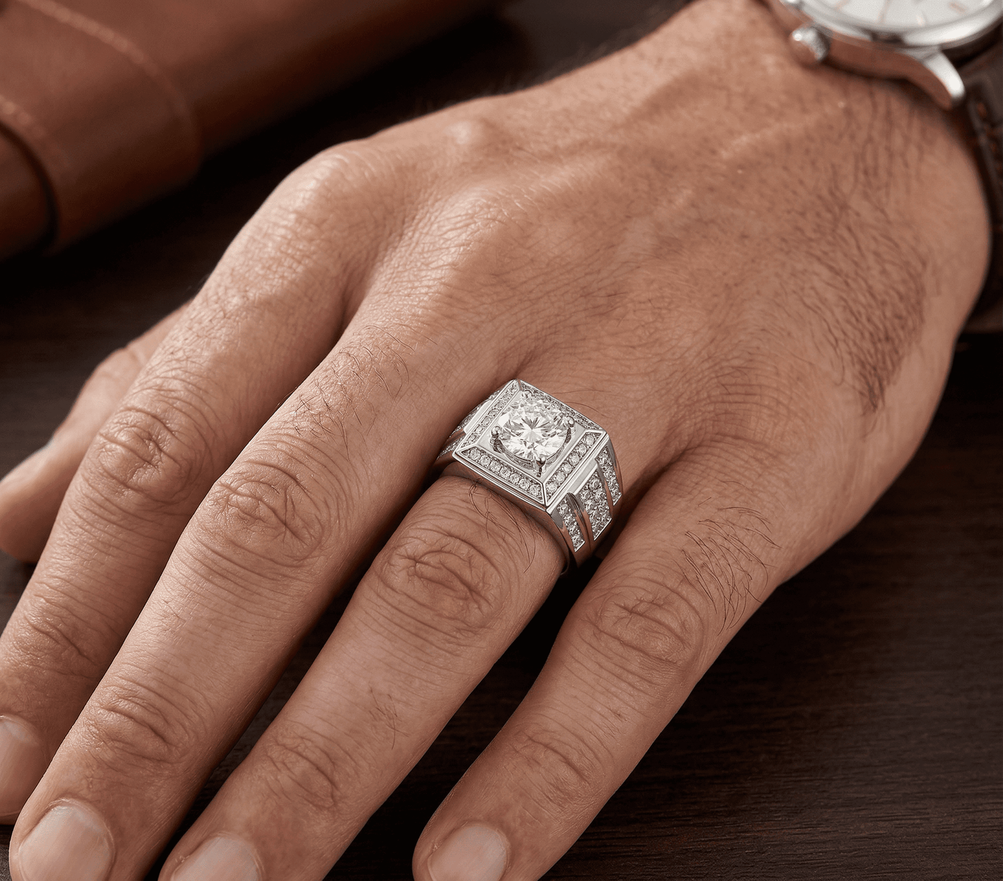 Valor moissanite ring worn on male model's hand, 1ct main stone 2.5ctw in 925 sterling silver lifestyle shot.