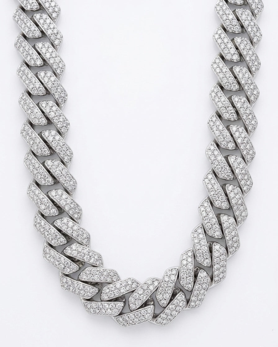 Silver cuban chain necklace with moissanite stones on a white background