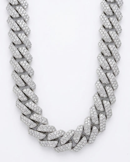 Silver cuban chain necklace with moissanite stones on a white background