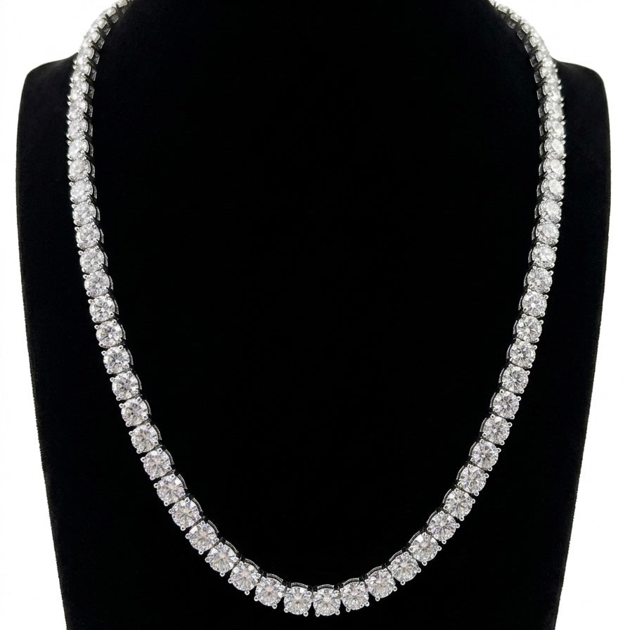Tennis silver moissanite necklace on a black stand with a white background
