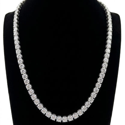 Tennis silver moissanite necklace on a black stand with a white background