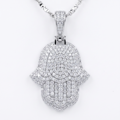 Silver Hamsa hand pendant with clear moissanite stones on a white background