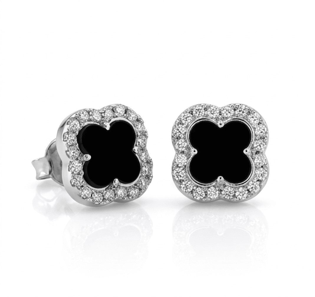 Pair of earrings with black clover-like centers and diamond-studded borders on a white background