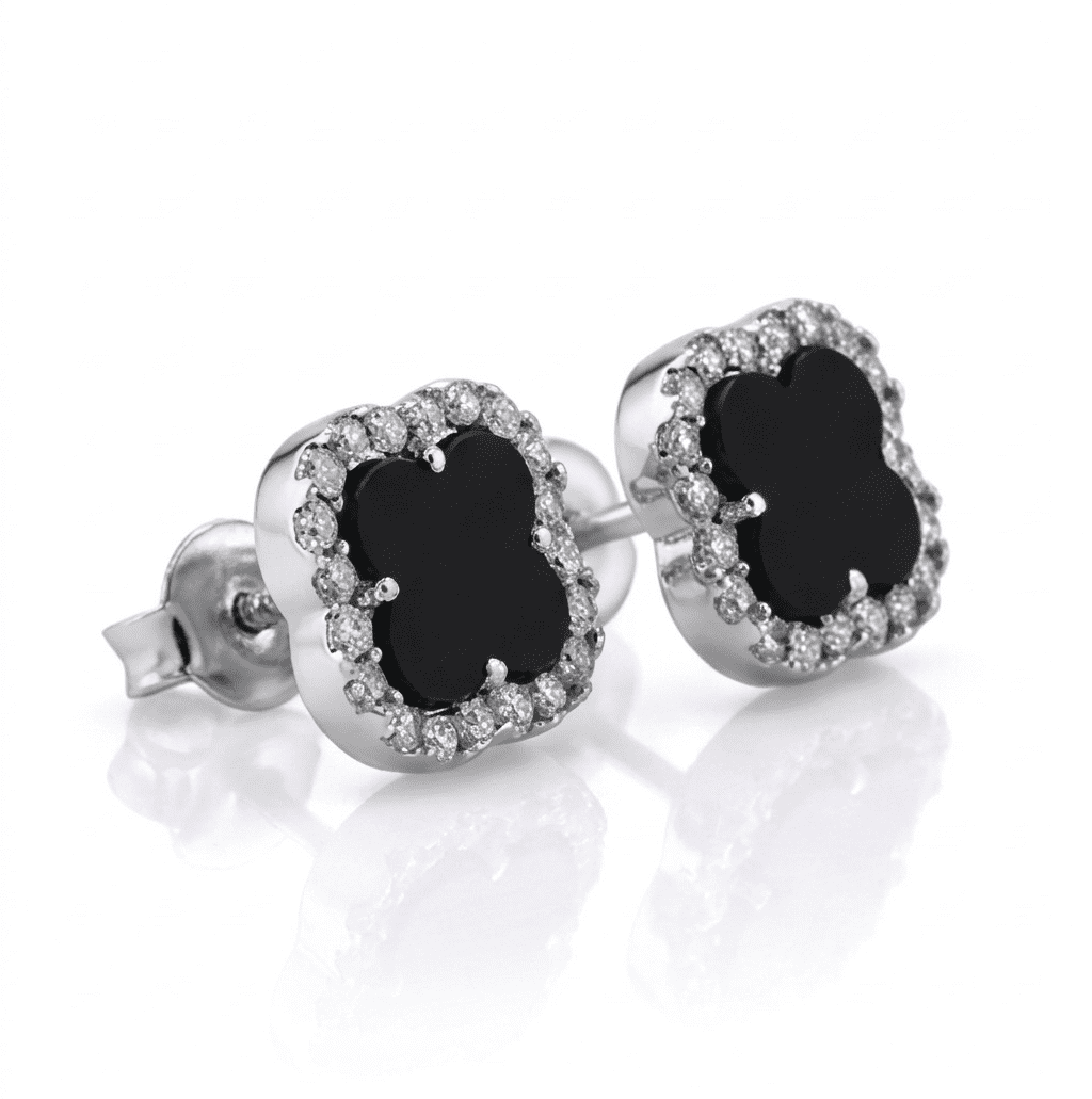 Pair of silver earrings with black gemstones on a white background