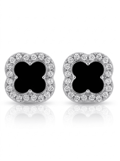 Pair of earrings with black clover-like centers and diamond-studded silver borders on a white background.