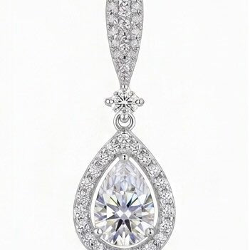 Close-up of Duchess moissanite drop earring showing brilliant pear cut main stone in sterling silver.