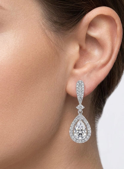 Duchess pear moissanite drop earrings worn on model's ear, 3.6ctw elegant lifestyle shot.