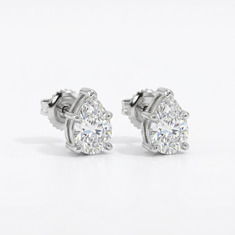Pair of pear shape diamond stud earrings on a white background