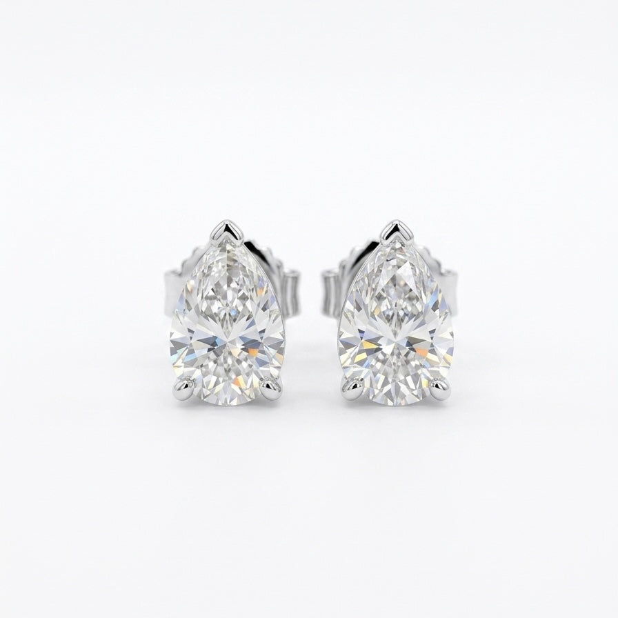 Pair of pear-shaped diamond stud earrings front view on a white background