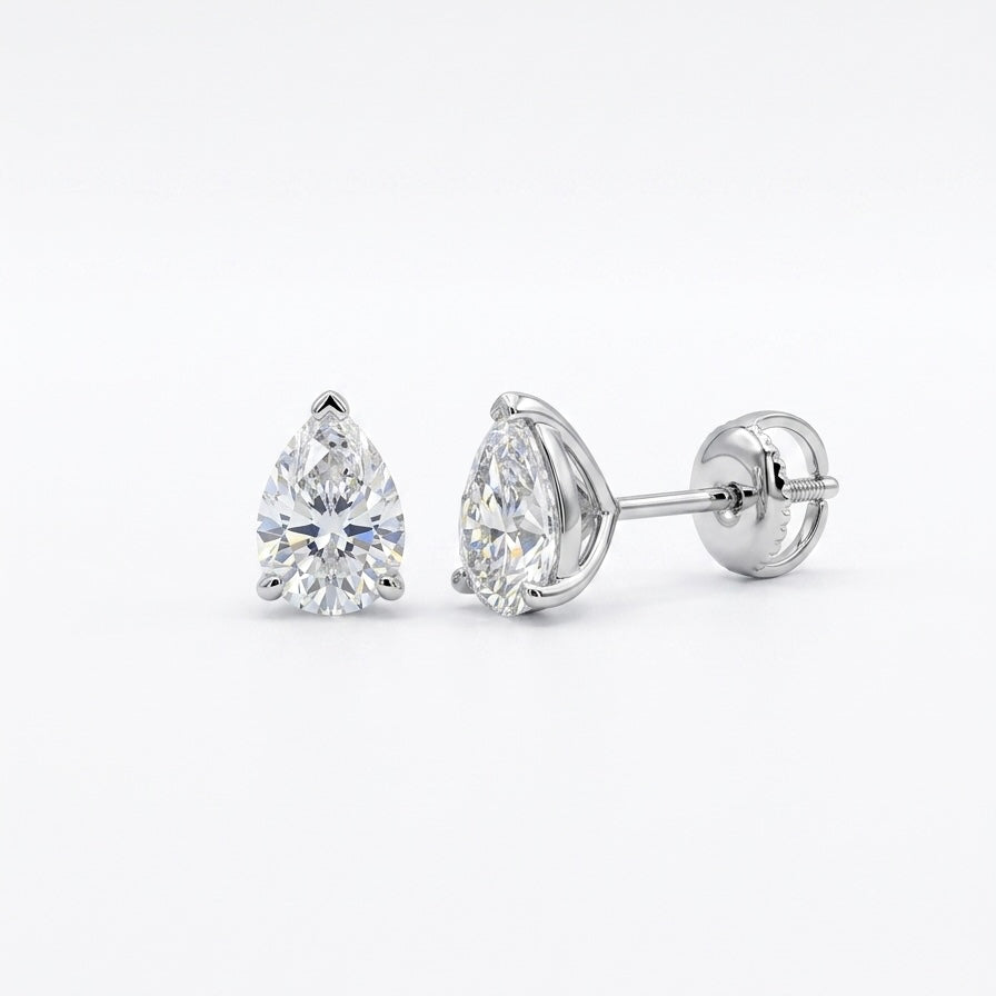 Pair of pear-shaped diamond stud earrings on a white background