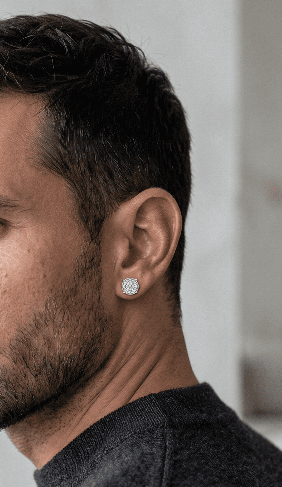 Maverick moissanite stud earrings worn on male model's ear, 1ctw hand set in 925 sterling silver.