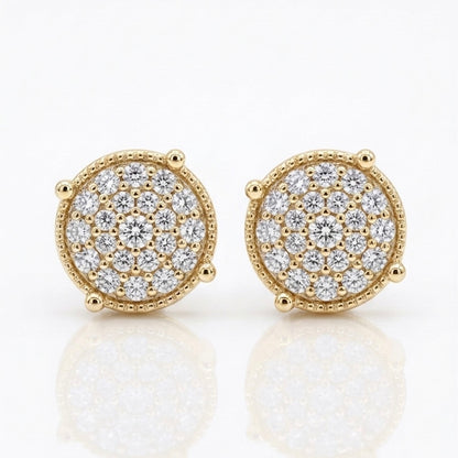 A pair of Maverick moissanite stud earrings in 18K yellow gold plated sterling silver on white background.