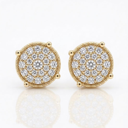 A pair of Maverick moissanite stud earrings in 18K yellow gold plated sterling silver on white background.