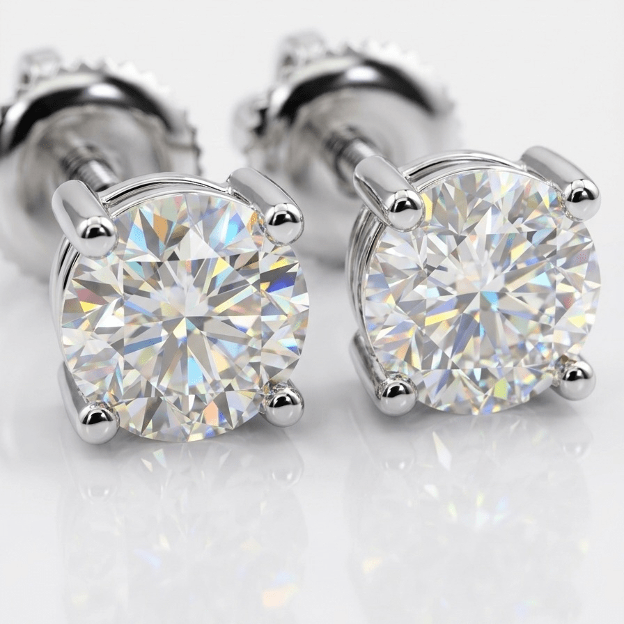Pair of silver moissanite stud earrings on a light gray background