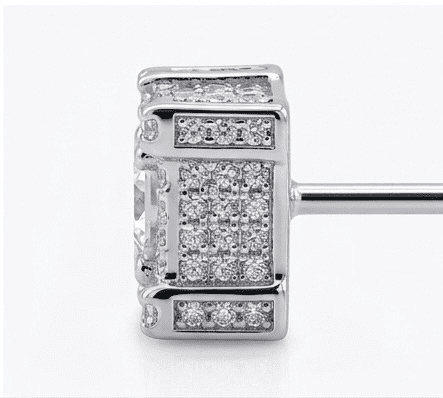 Silver earring with diamond accents on a white background