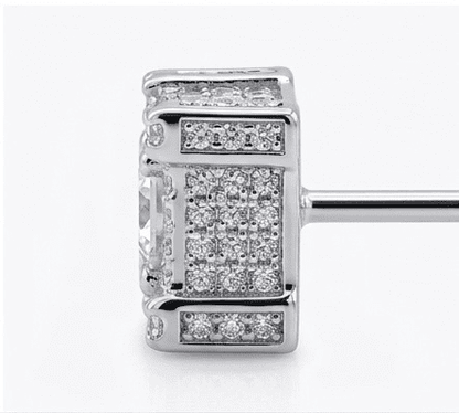 Silver earring with diamond accents on a white background