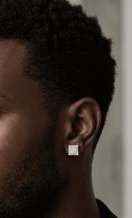 Man wearing a diamond earring with a neutral background