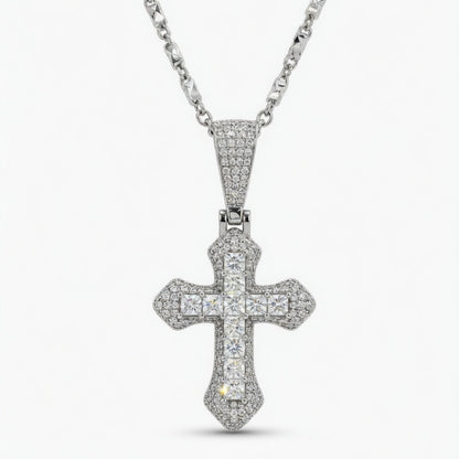 moissanite cross pendant on a chain against a white background
