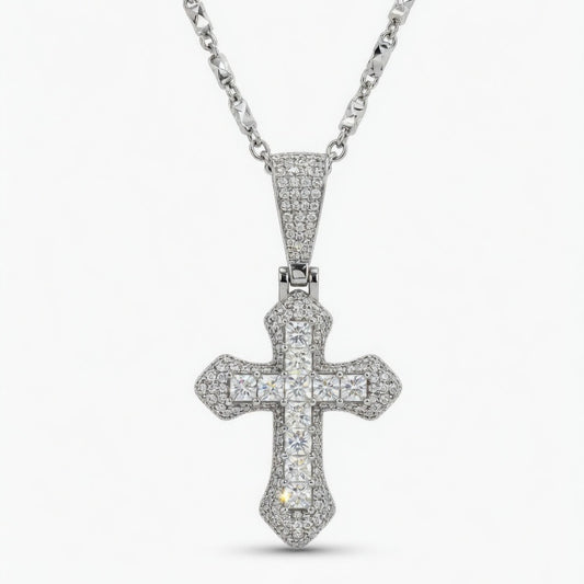 moissanite cross pendant on a chain against a white background