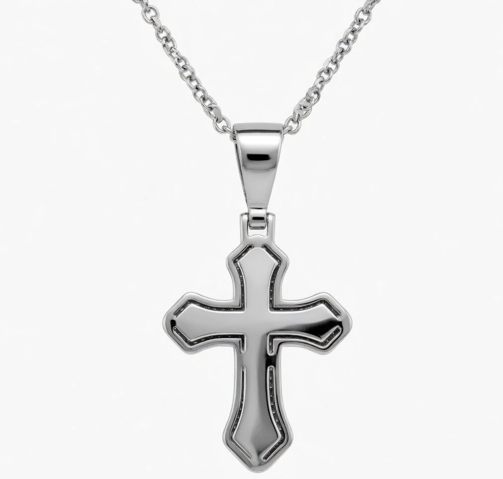 Silver cross pendant on a chain against a white background