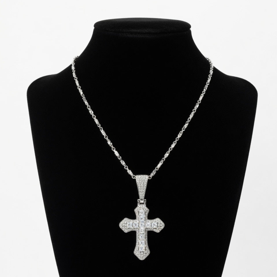 Silver moissanite cross pendant necklace on a black mannequin bust with a white background