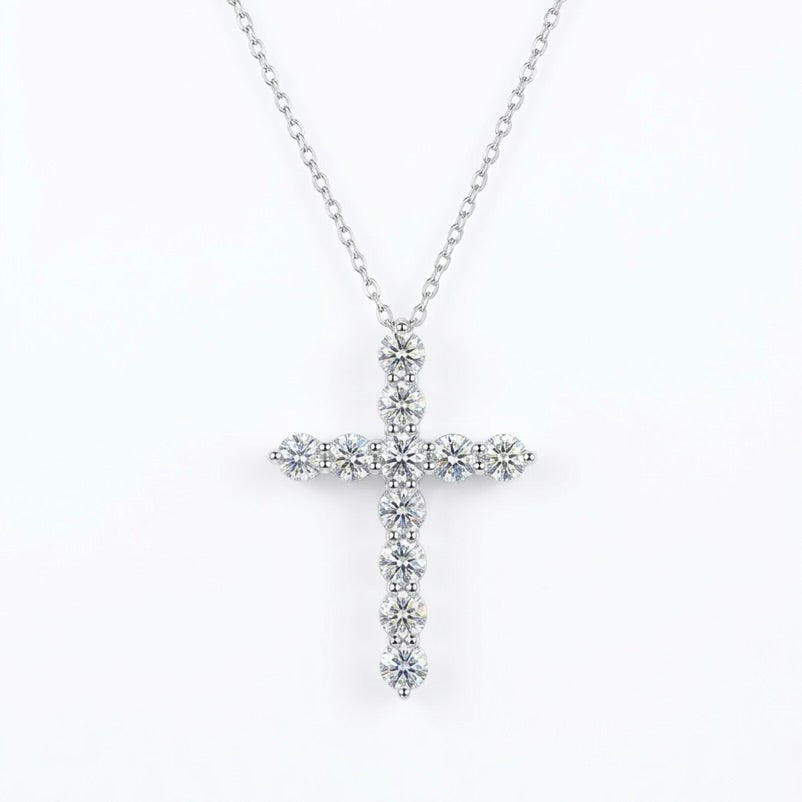 Silver moissanite cross necklace with clear stones on a white background