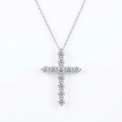 Silver moissanite cross necklace with clear stones on a white background