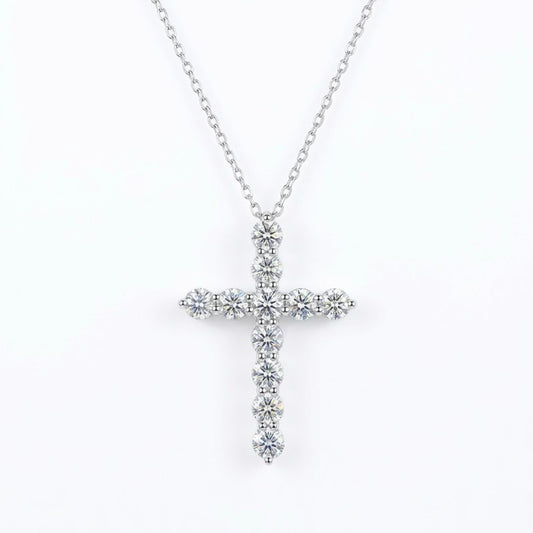 Silver moissanite cross necklace with clear stones on a white background
