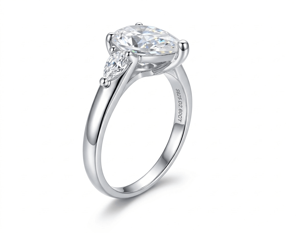 45-degree view of Aurora 2ct pear moissanite ring, 2.2ctw brilliant pear cut stone in sterling silver band.