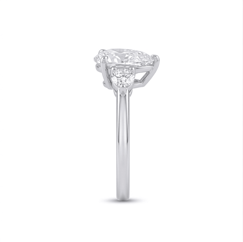 Side view of Aurora 2ct pear moissanite ring, 2.2ctw in sterling silver band showing elegant pear stone profile.