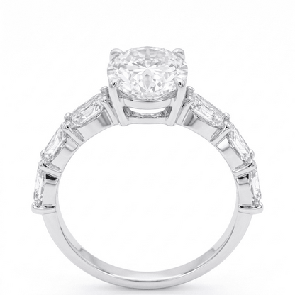 Moissanite ring with a oval central gemstone and smaller stones on a white background