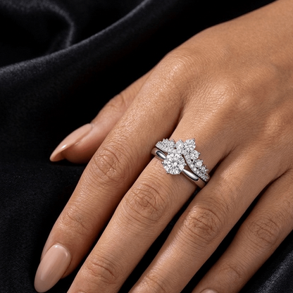 Evermore moissanite cluster ring stacked with brilliant solitaire on finger, 925 sterling silver lifestyle styling shot.