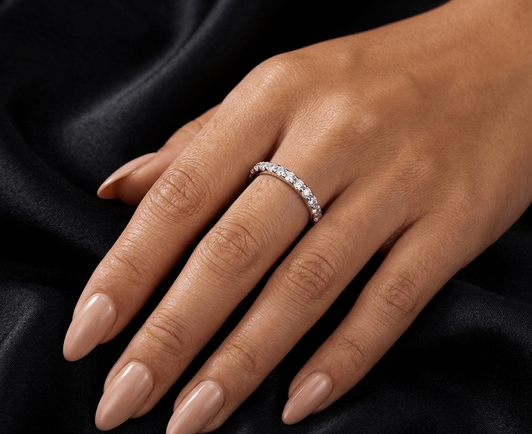 half Eternity moissanite ring worn on finger, hand set stone band in 2mm 925 sterling silver lifestyle shot.