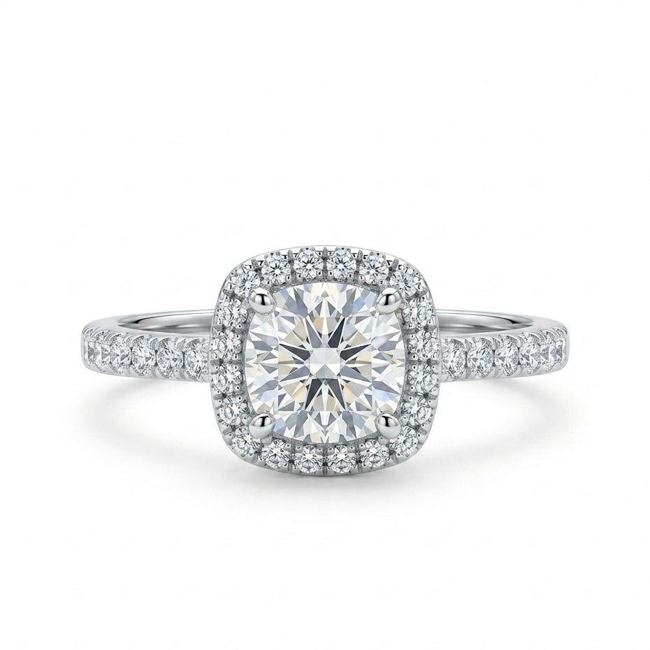 Diamond ring with a cushion-cut center stone and halo on a white background