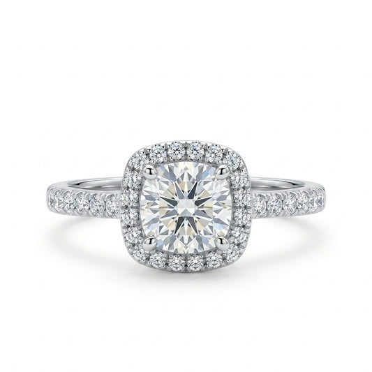 Diamond ring with a cushion-cut center stone and halo on a white background