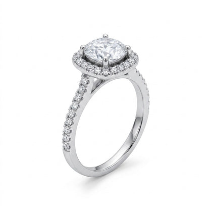 Diamond ring with a central gemstone and halo on a white background