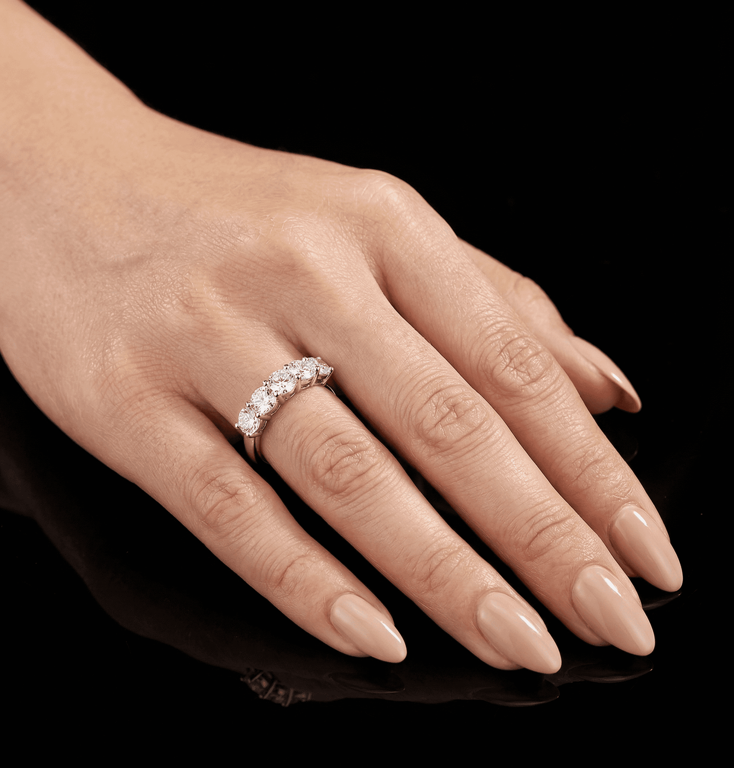 Sevenfold moissanite ring worn on finger, 7 oval stones hand set in 925 sterling silver lifestyle shot.