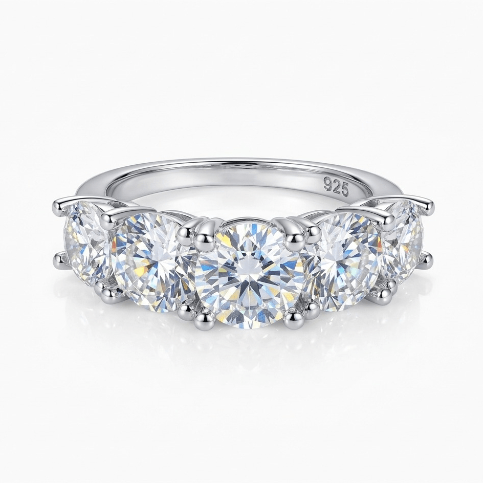Silver ring with five clear moissanite on a white background