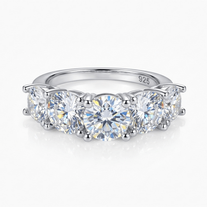 Silver ring with five clear moissanite on a white background