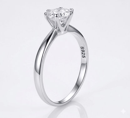 Silver ring with a moissanite on a light gray background