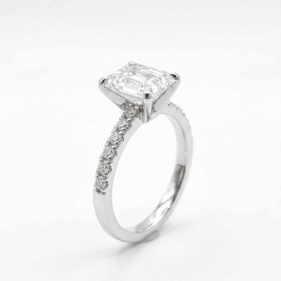 Radiant cut moissanite engagement ring in 925 sterling silver rhodium plated with pave band. Sparkling diamond alternative.
