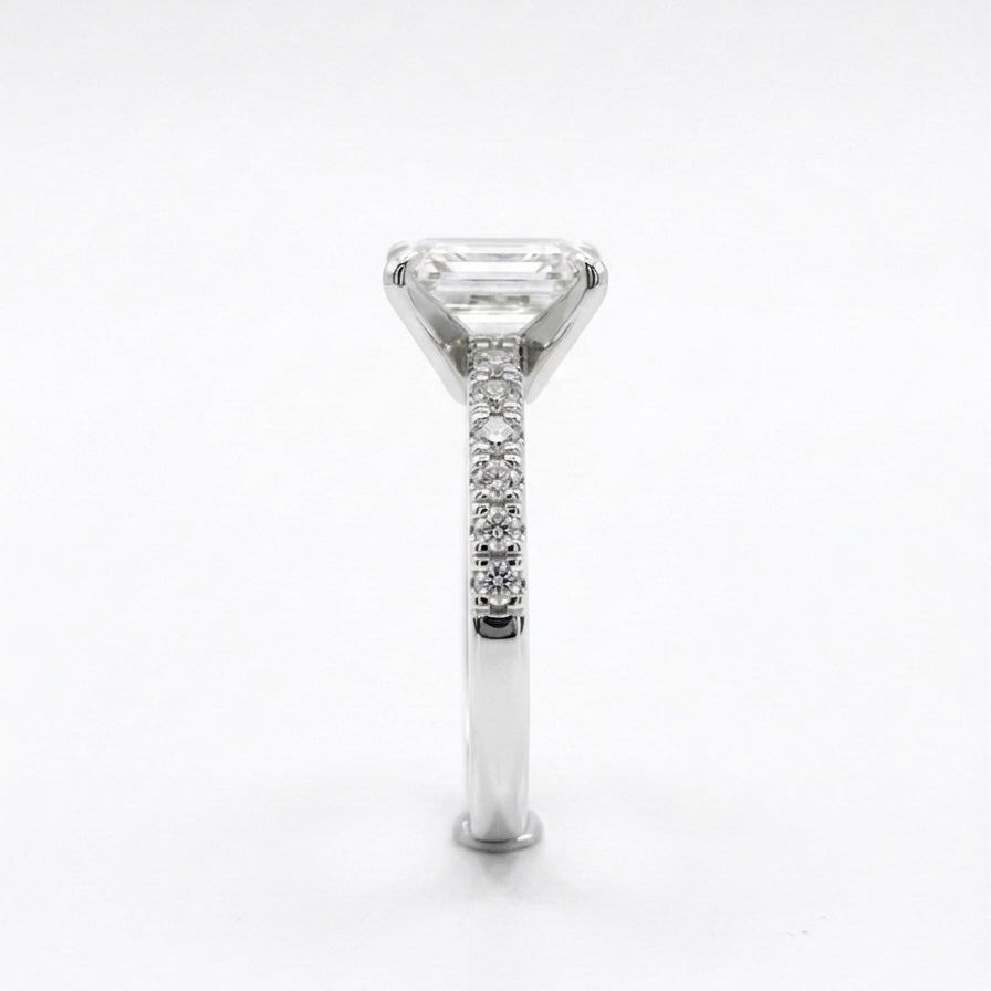 Moissanite fully hand set ring with a white gold band on a light grey background