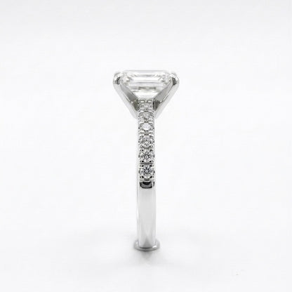Moissanite fully hand set ring with a white gold band on a light grey background