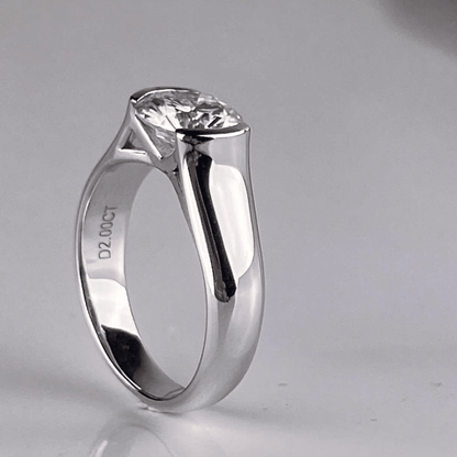 45-degree view of Whisperglow 2ct moissanite ring, brilliant cut stone in sterling silver stackable band.