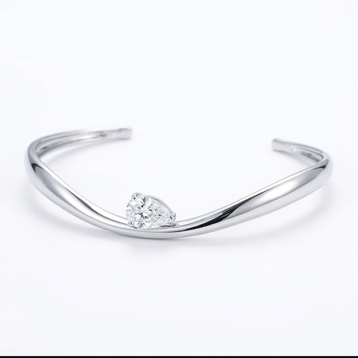 Helena moissanite bangle with 2ct pear main stone, hand set in 925 sterling silver, front view.