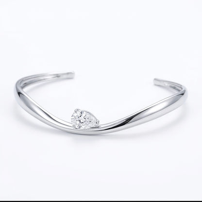 Helena moissanite bangle with 2ct pear main stone, hand set in 925 sterling silver, front view.