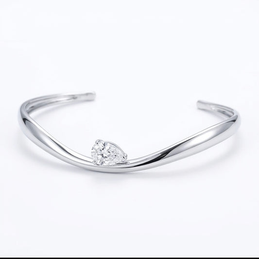 Helena moissanite bangle with 2ct pear main stone, hand set in 925 sterling silver, front view.