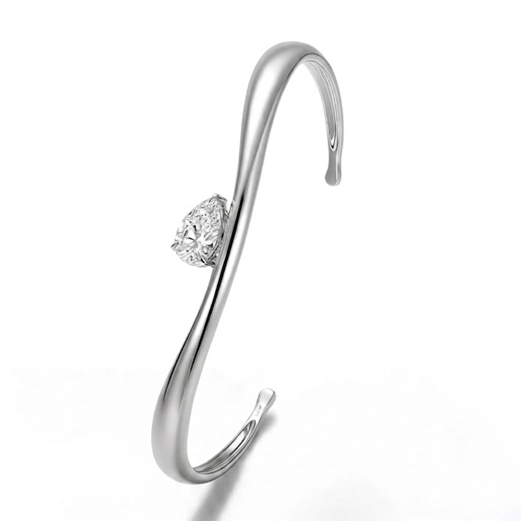 Close-up of Helena moissanite bangle showing brilliant 2ct pear cut centre stone in sterling silver.